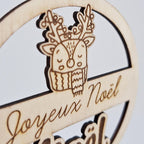Gros plan sur le renne gravé de la boule de Noël en bois